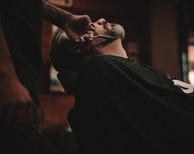 man sitting on barber's chair