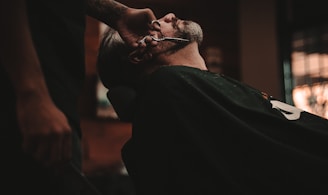 man sitting on barber's chair