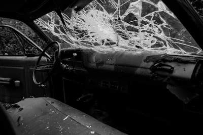 Interior view of a salvage car showing dashboard and seats.