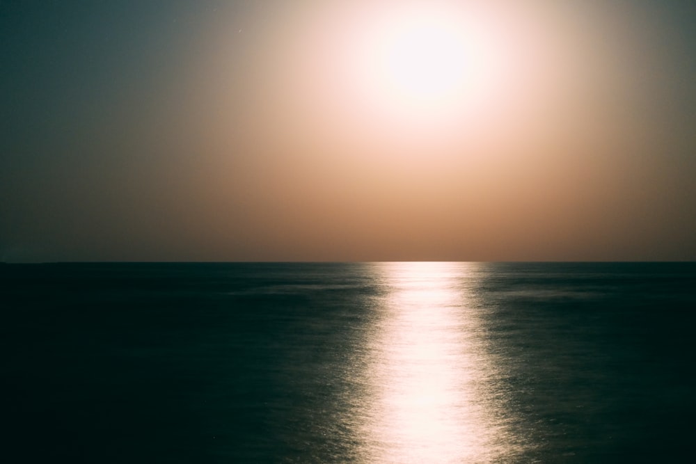 calm body of water during day time