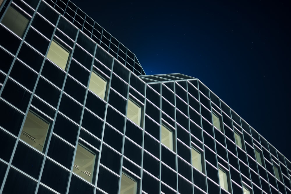 low angle photography of black building during night