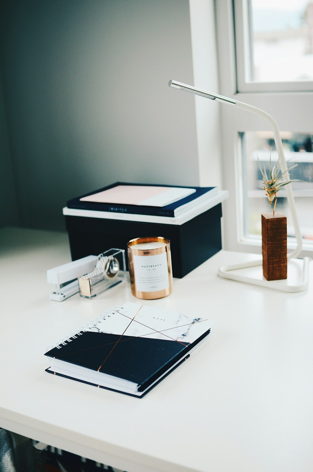 stapler beside tape and box on desk