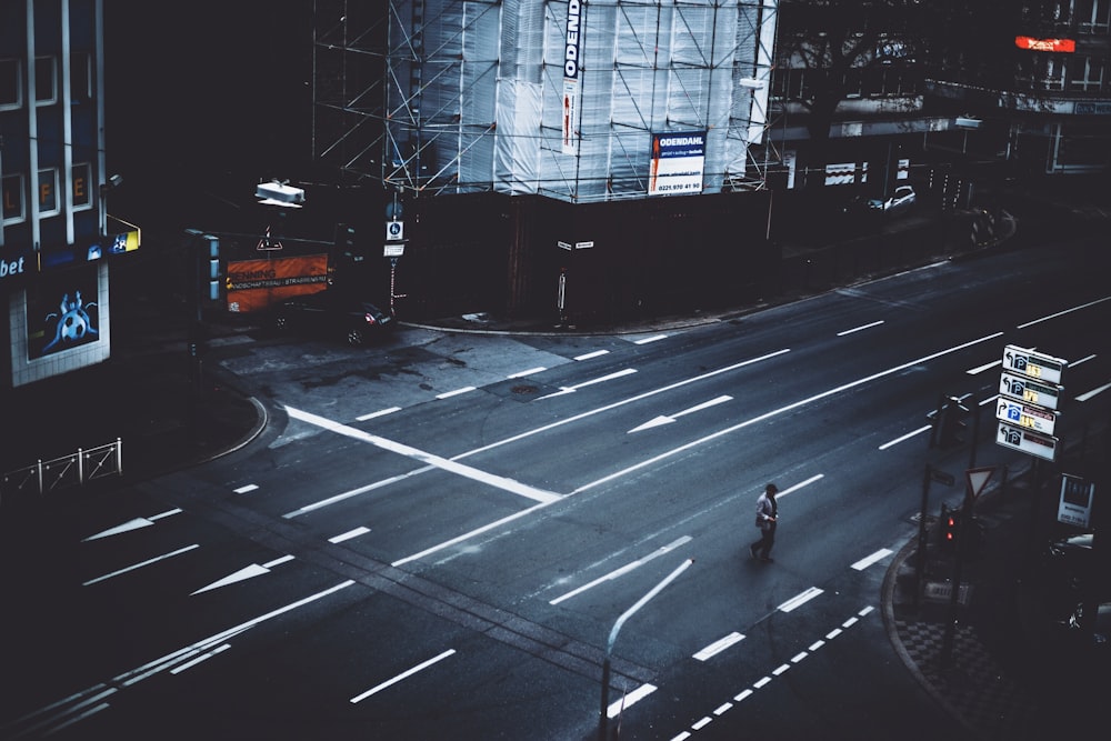 Persona que camina por la carretera cerca del edificio durante el día