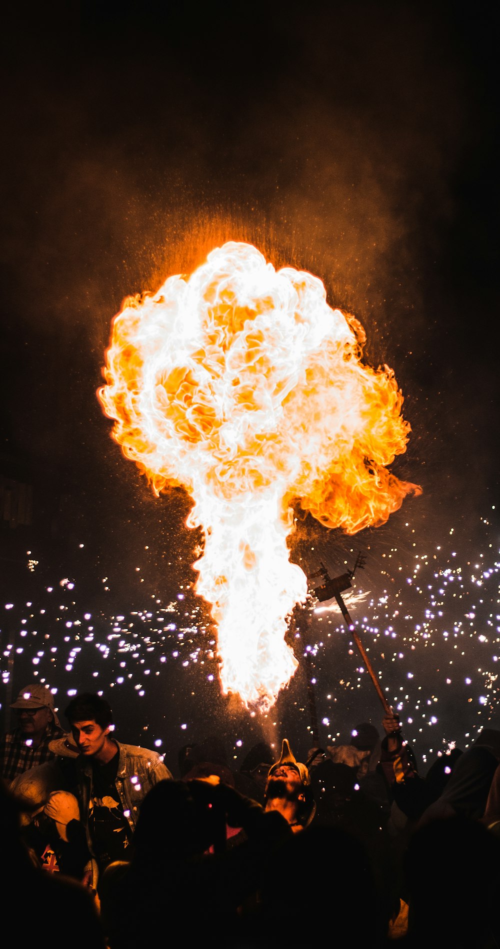 man blowing fire from his mouth at night