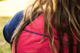 Vibrant balayage on long hair catching the sunlight in a salon setting.