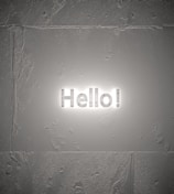 Close-up of a 5-foot Elegant Glow Sign mounted on a textured wall, showcasing the soft halo of LED light.