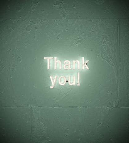 A warm thank you message displayed on a screen with a smiling face icon.