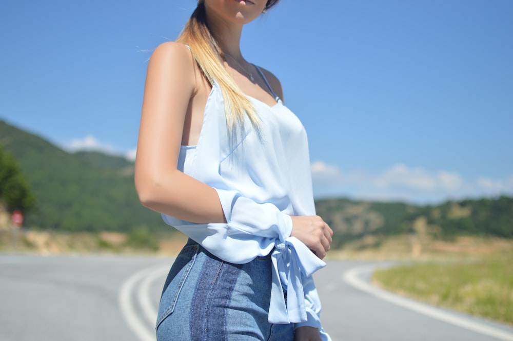 woman standing on asphalt road