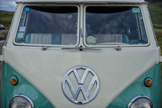 A close-up of the white VW T5 California Beach’s dashboard showing its classic, used charm.
