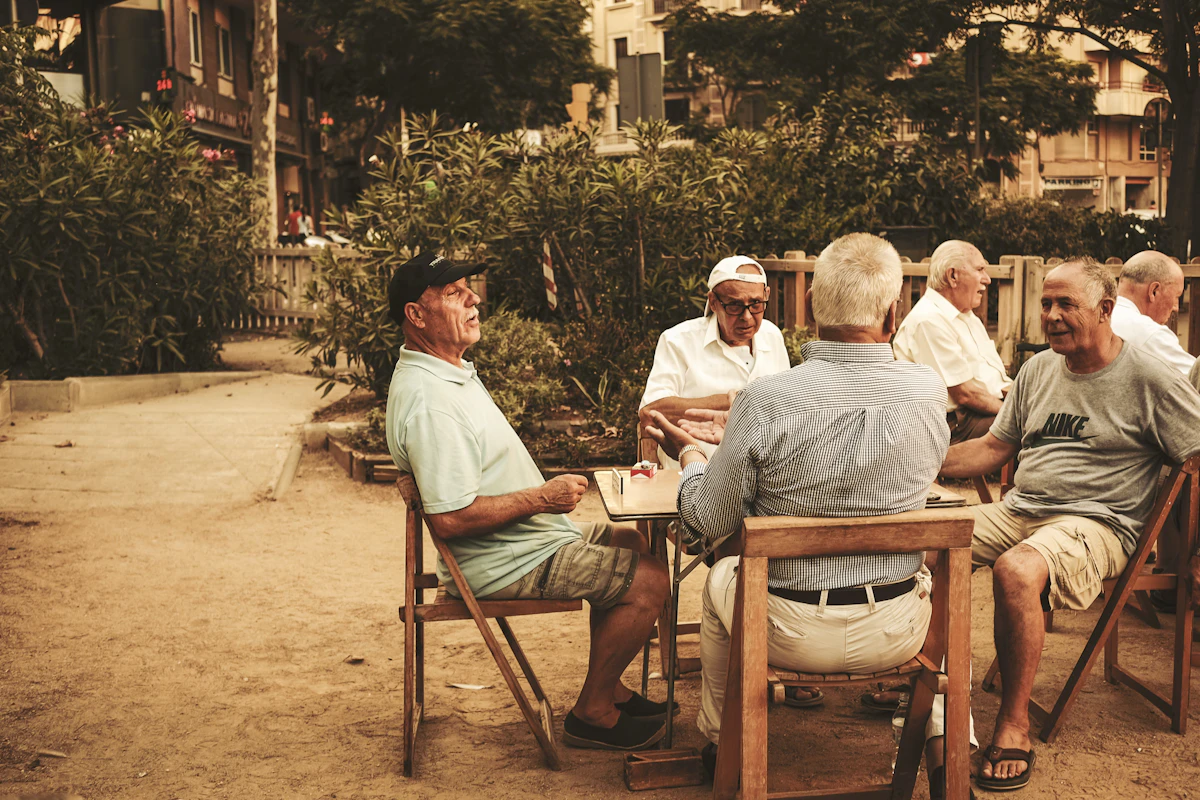 A couple sitting close together on a bench in soft, golden evening light