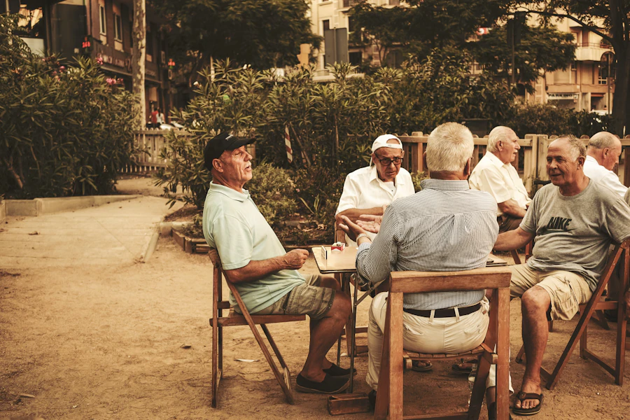 An older couple sitting close together on a bench, enjoying a quiet golden evening