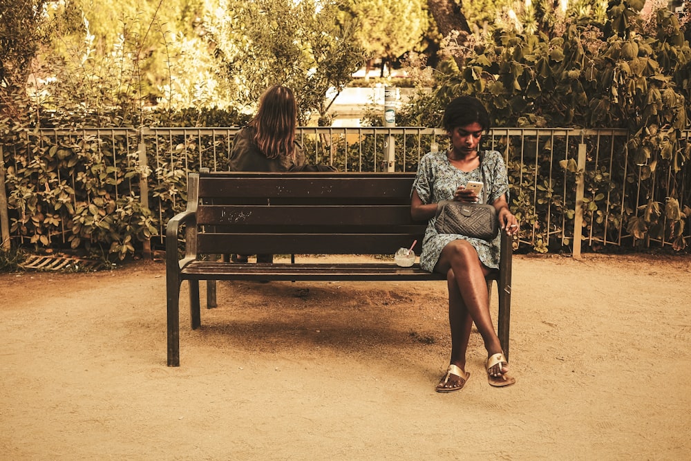 woman wearing floral dress sitting on bench