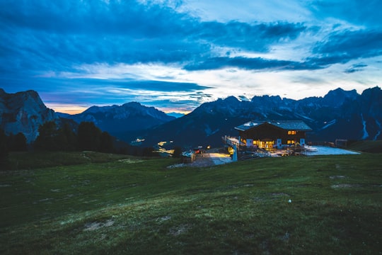 house near mountains under blue sky during sunset in Pozza di Fassa Italy