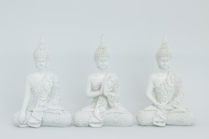 three Gautama Buddah ceramic figurines