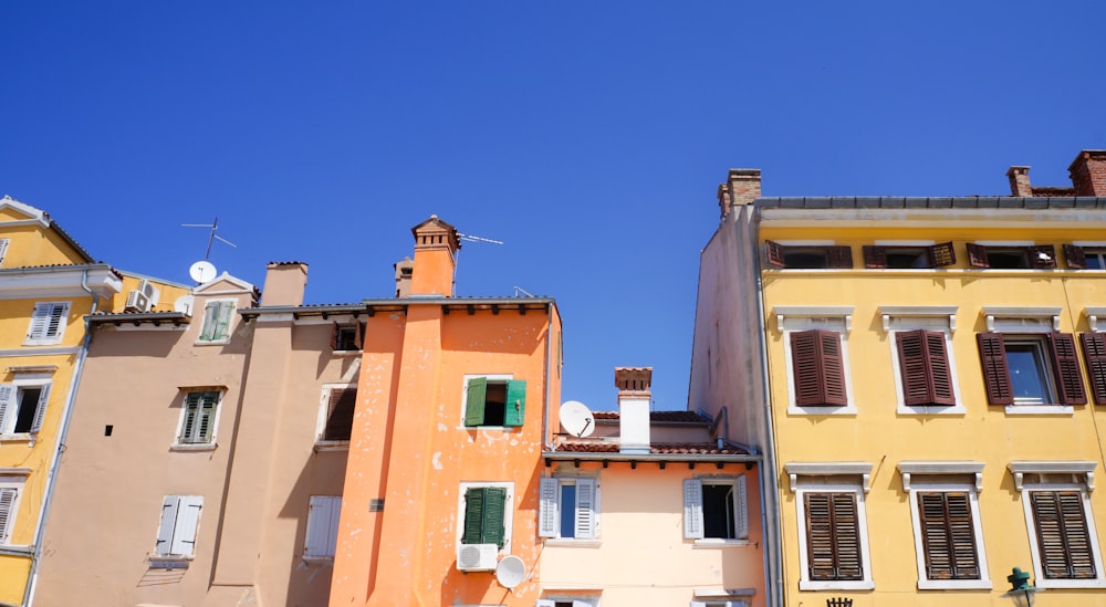 yellow and orange concrete buildings under blue sky during daytime