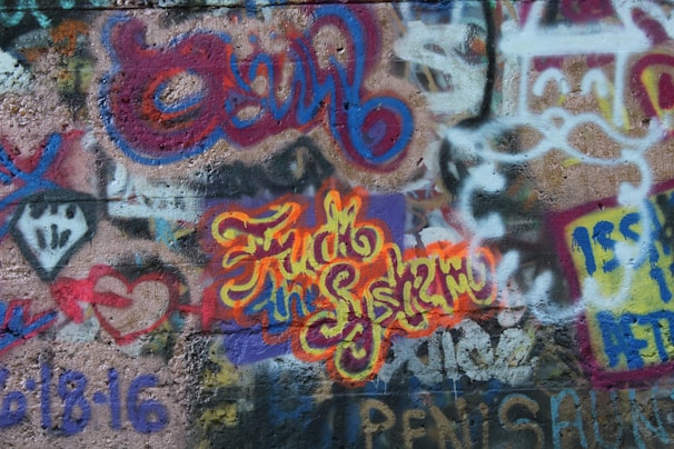 A vibrant mural featuring bold graffiti and bilingual text.