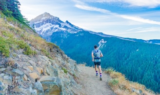man running on edge near mountain