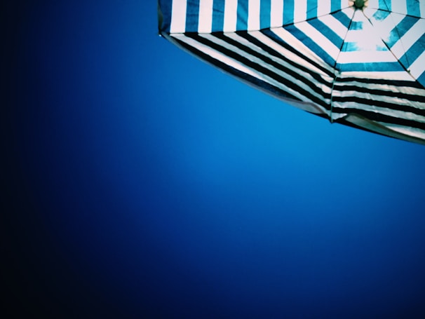 A stylish blue umbrella with a unique pattern.