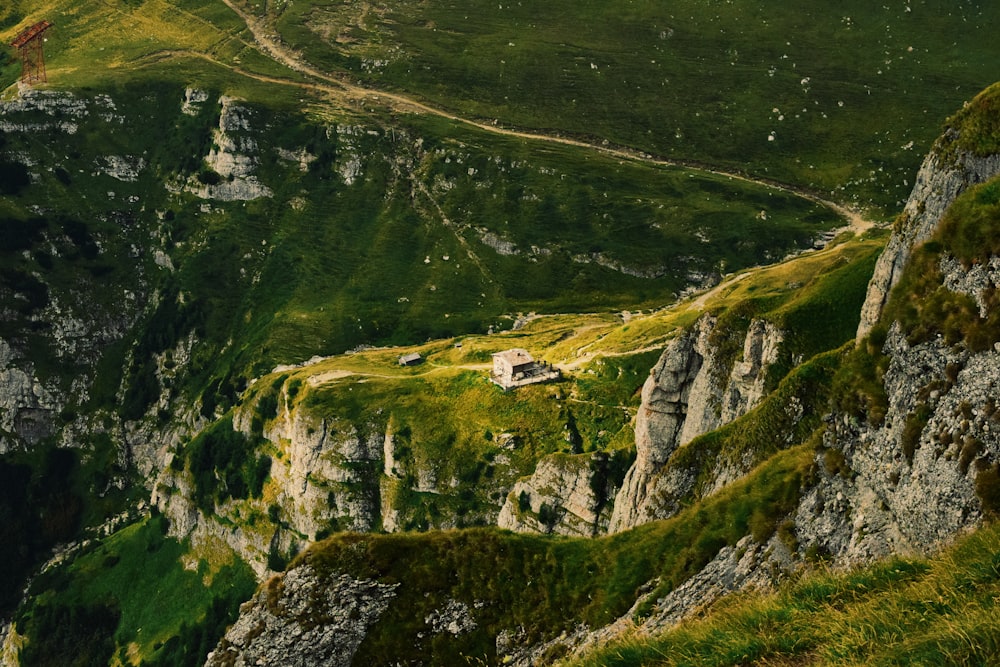 green grass covered mountain with white house