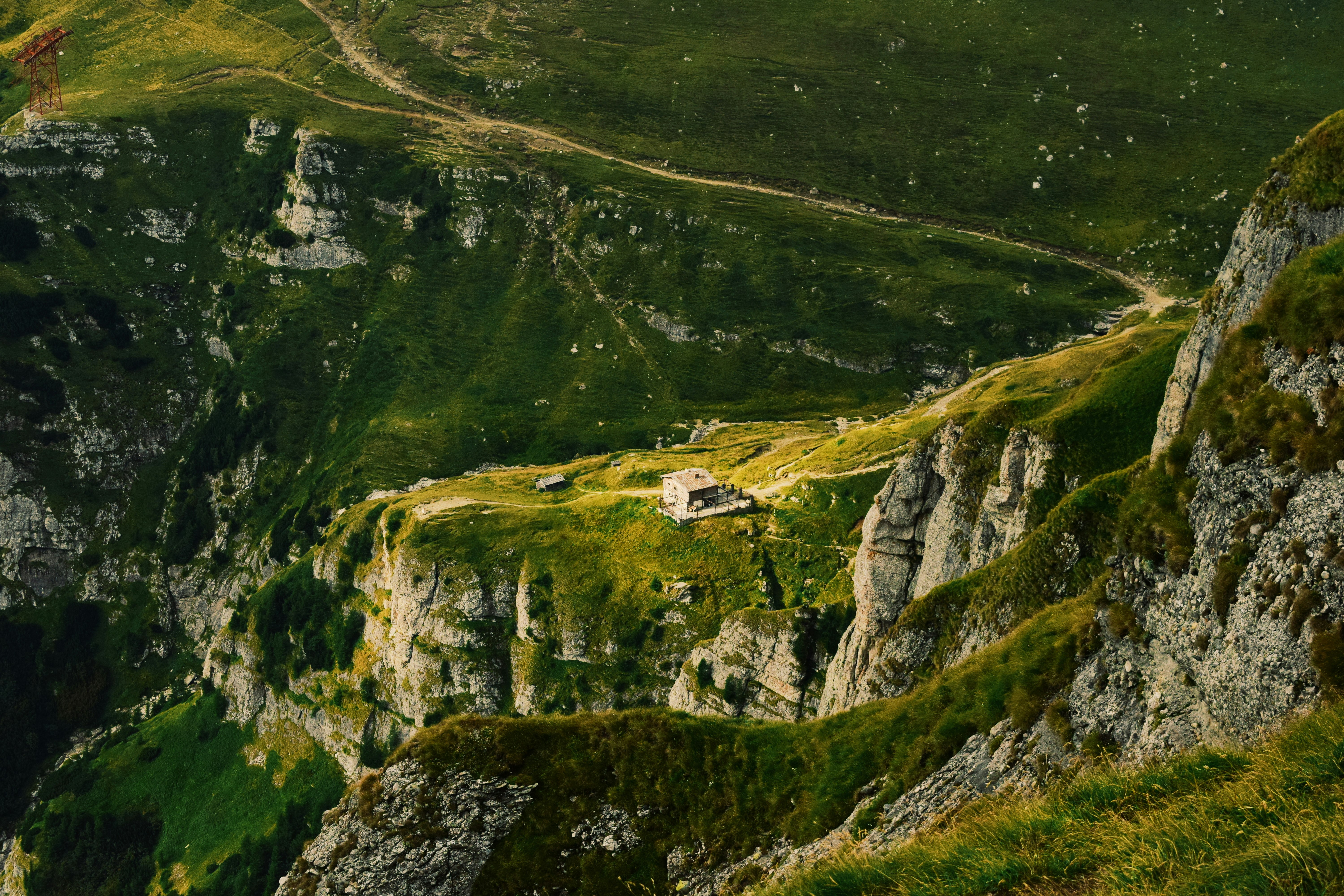 green grass covered mountain with white house