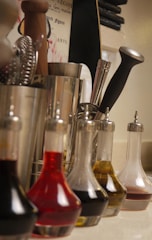 A clean kitchen countertop with various bottles of cleaning liquids arranged neatly.
