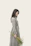 woman wearing grey dress holding flowers