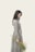 woman wearing grey dress holding flowers