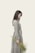 woman wearing grey dress holding flowers