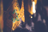 Close-up of vibrant upcycled fabrics being skillfully sewn by Tanzanian artisans.