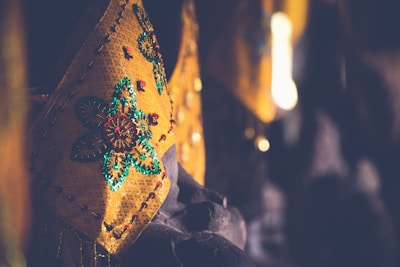 A close-up of vibrant, high-quality fabrics and fashionable accessories typical of the Yemeni style.