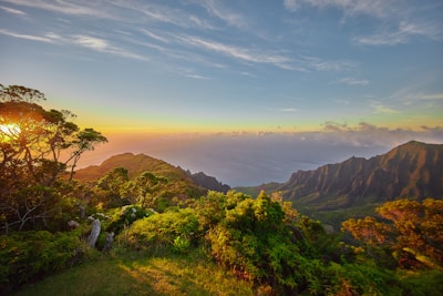 A sweeping landscape of Réunion’s lush mountains and coastline at golden hour.