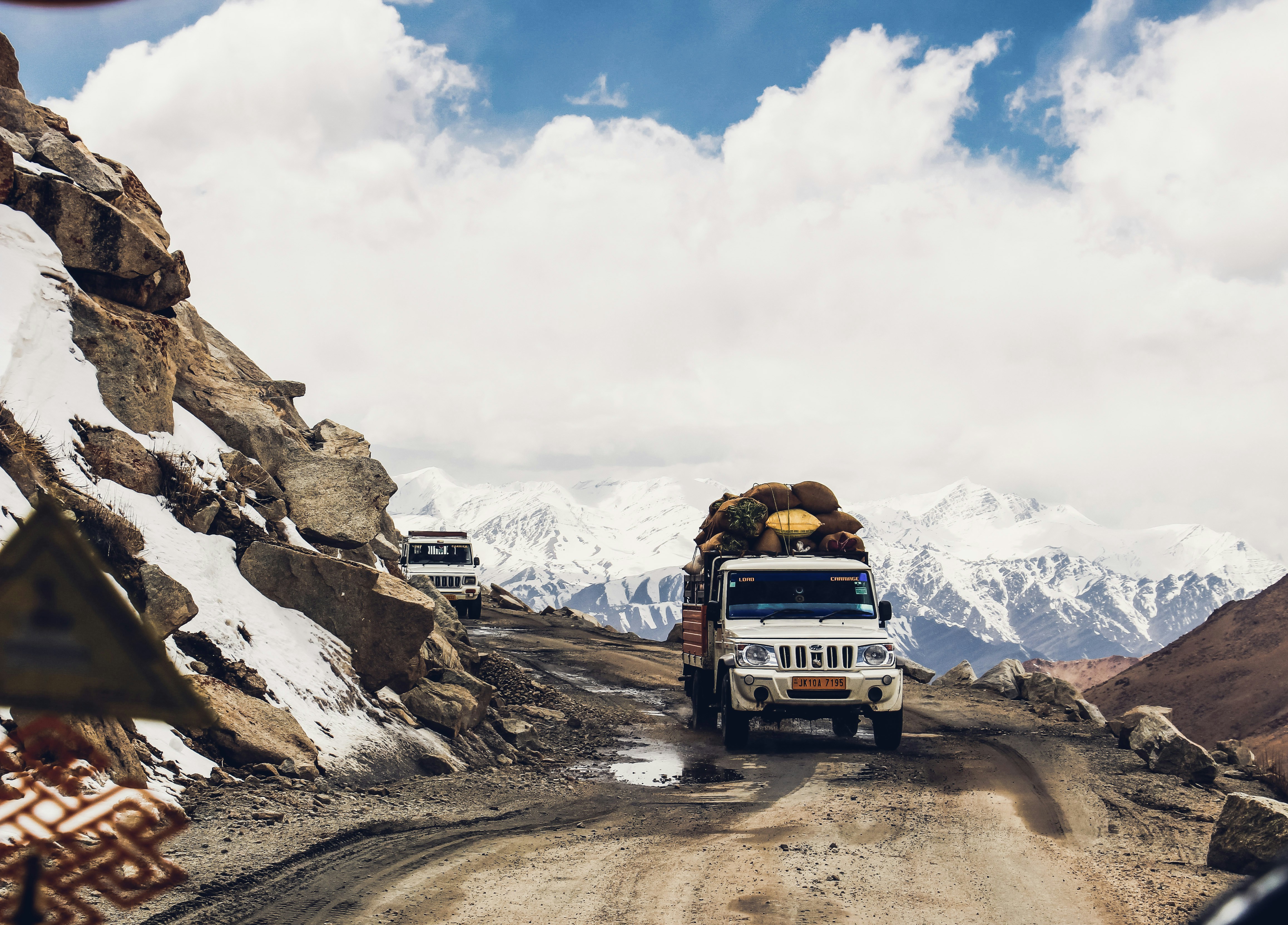 white vehicle passing through mountain