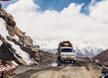 white vehicle passing through mountain