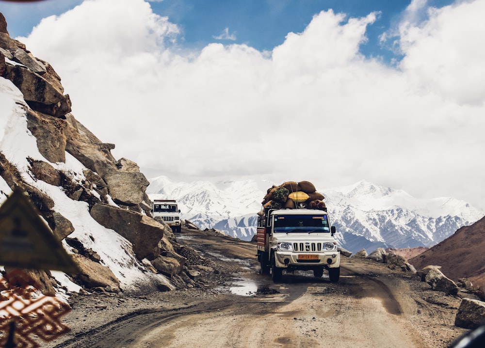 white vehicle passing through mountain