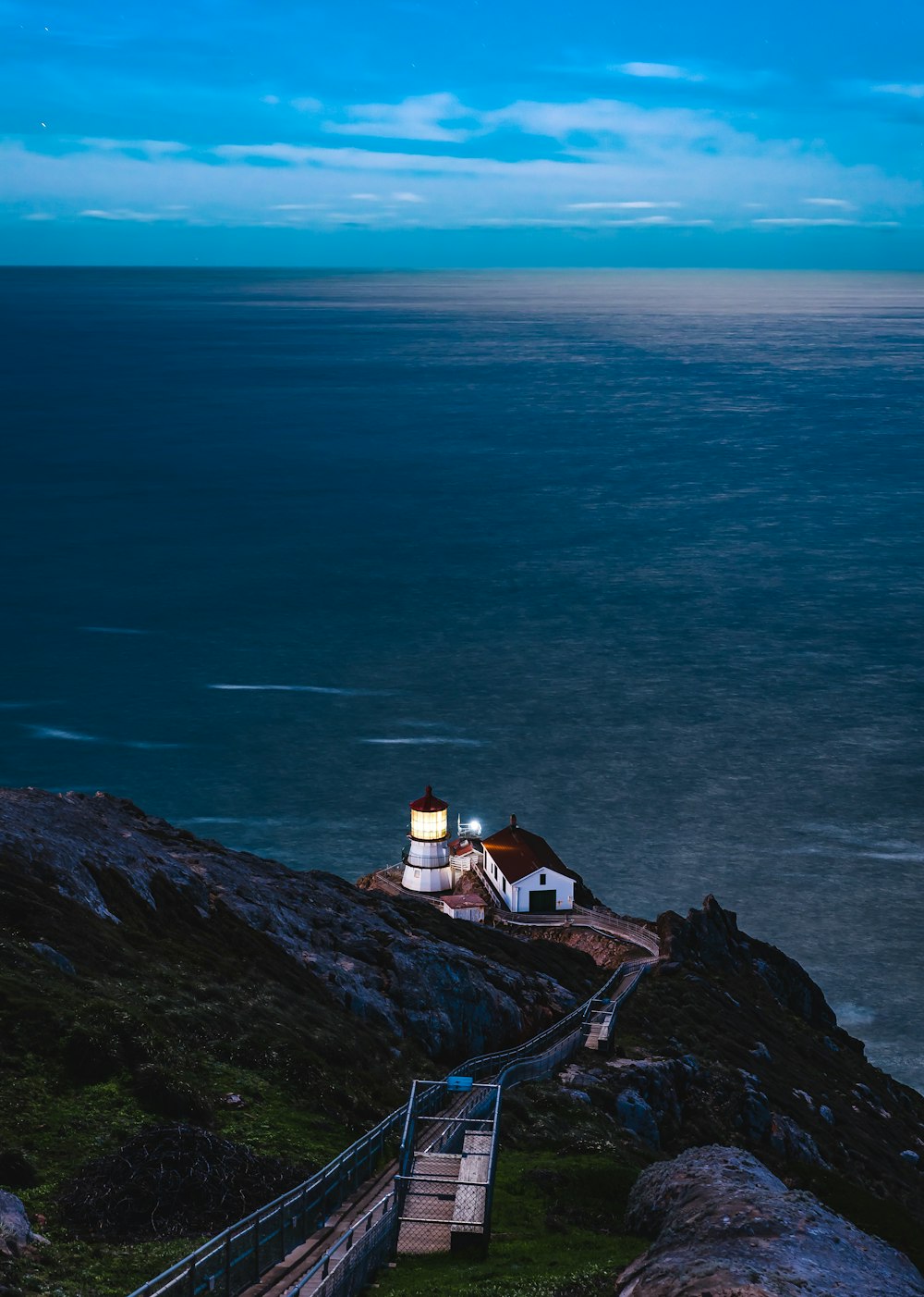 aerial view of white and tower near shore