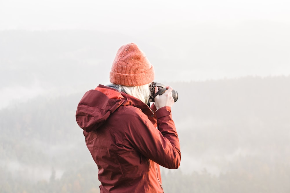 woman using DSLR camera