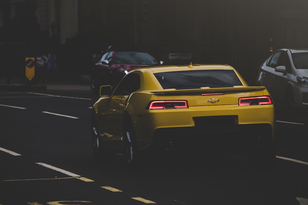 yellow Chevrolet Camaro on road