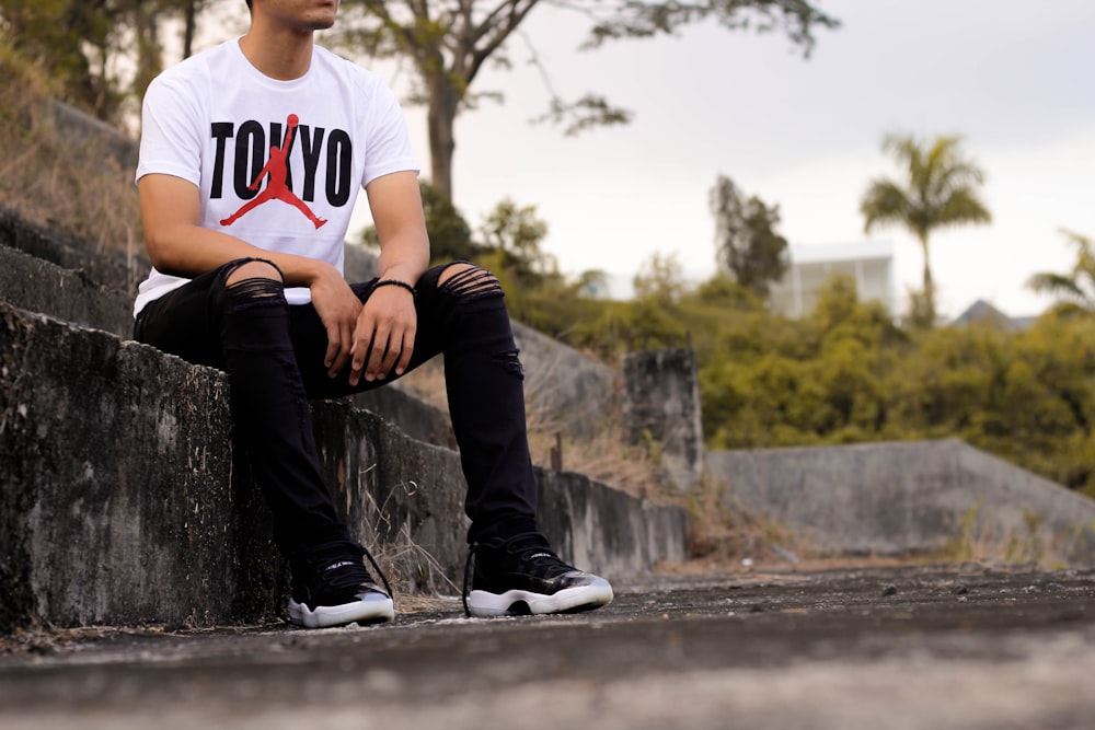 man sitting on concrete