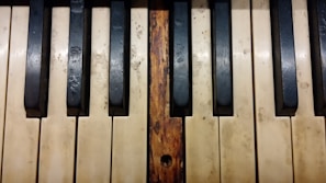 Close-up of a piano lid with deep scratches before repair.