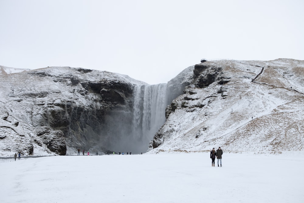 two peoples standing in snow