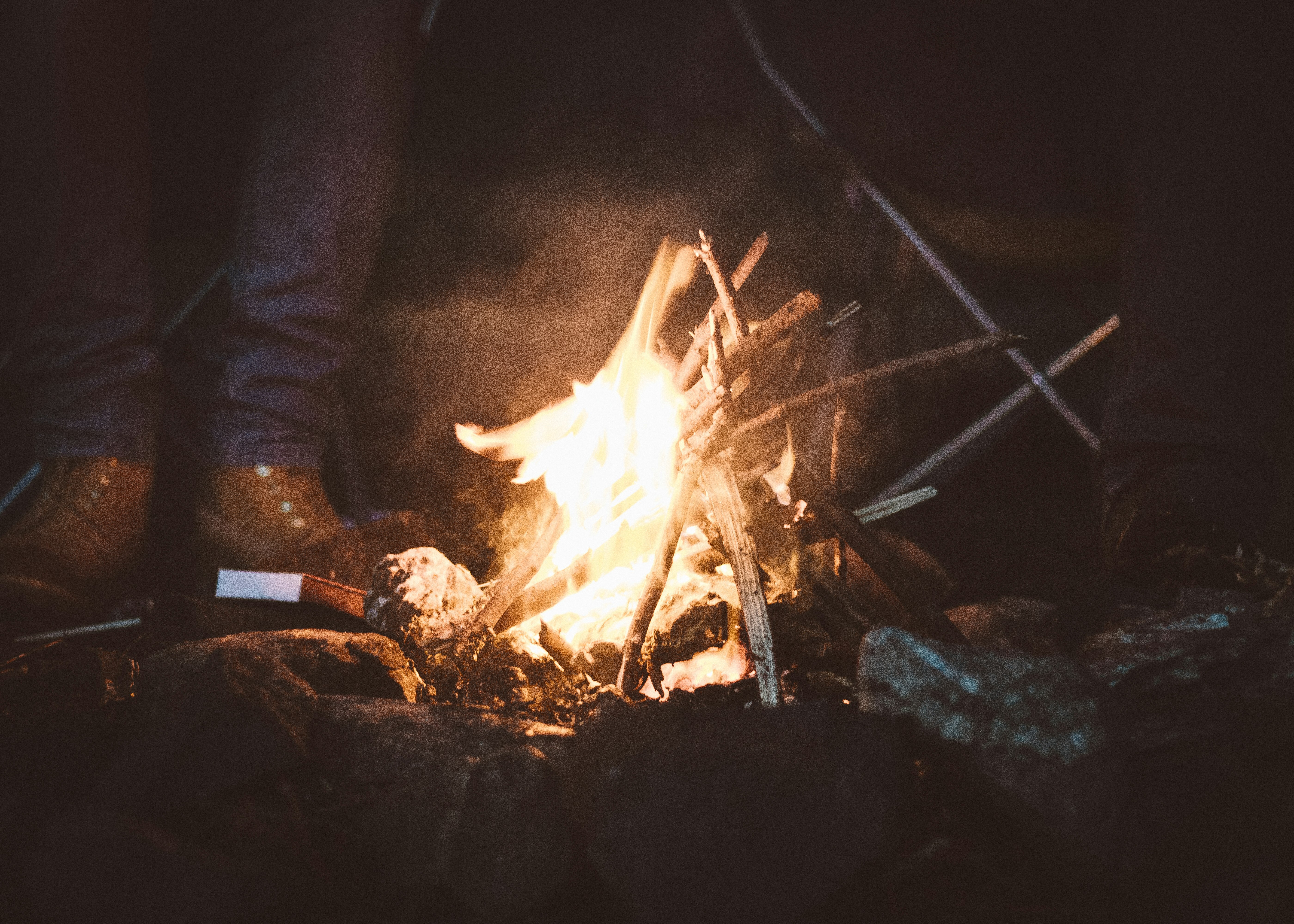 person standing near campfire