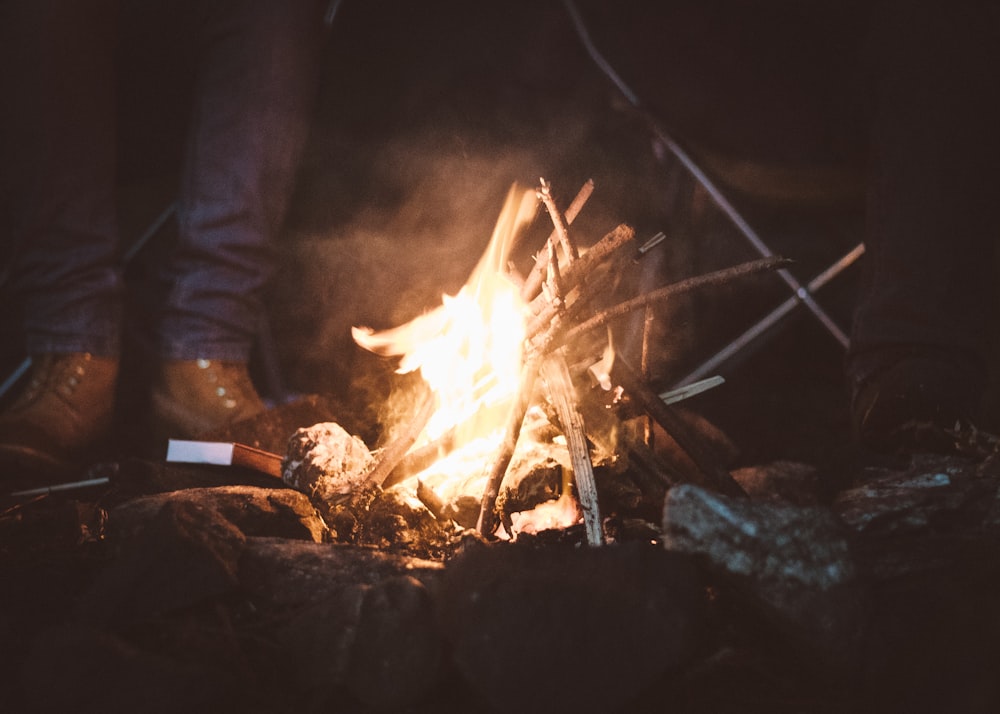 person standing near campfire