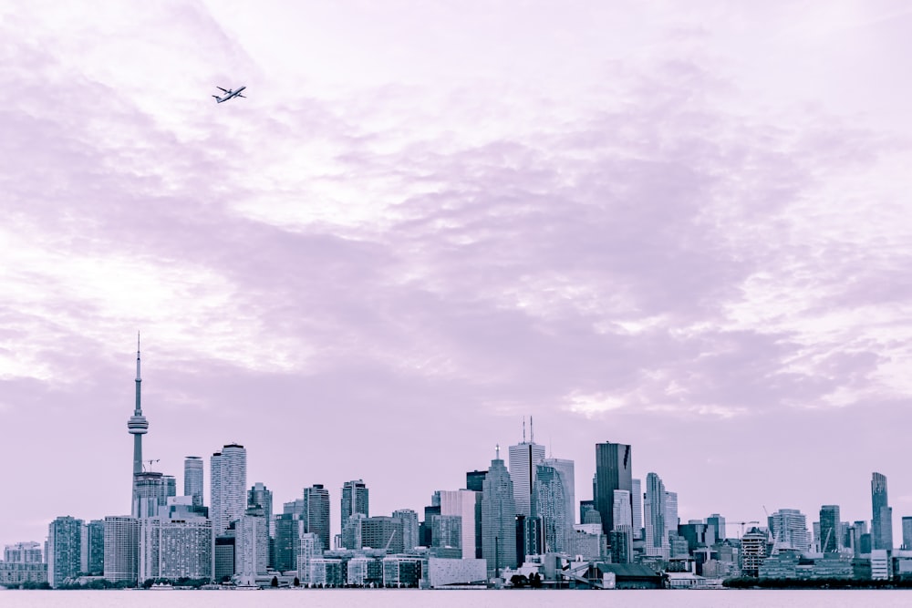 photography of city scape under plane at daytime