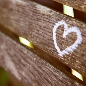 brown wooden panel with white heart