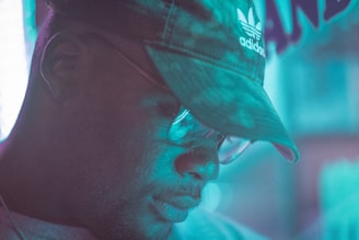 A calm, professional portrait of a coach in a softly lit, minimalistic office setting.