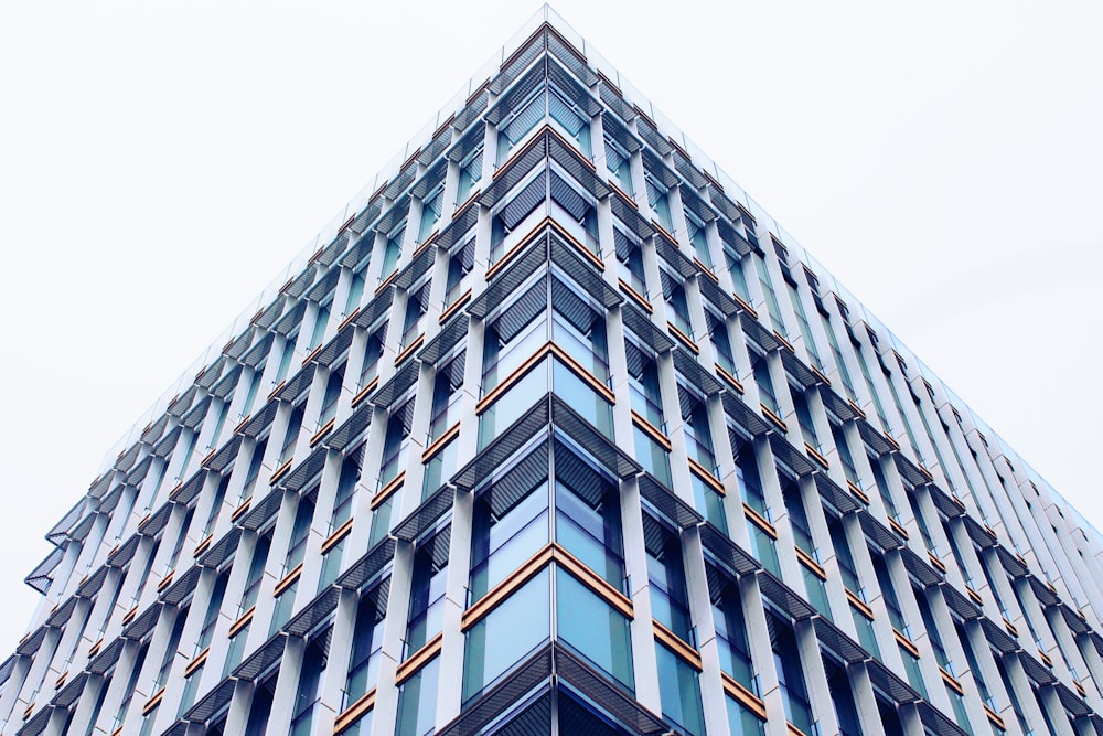 edificio de hormigón blanco y verde bajo nubes blancas durante el día