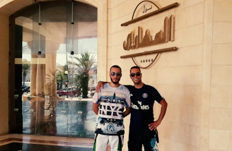 Jan Simon and Daniel Simon warmly greeting a client outside their California therapy office.