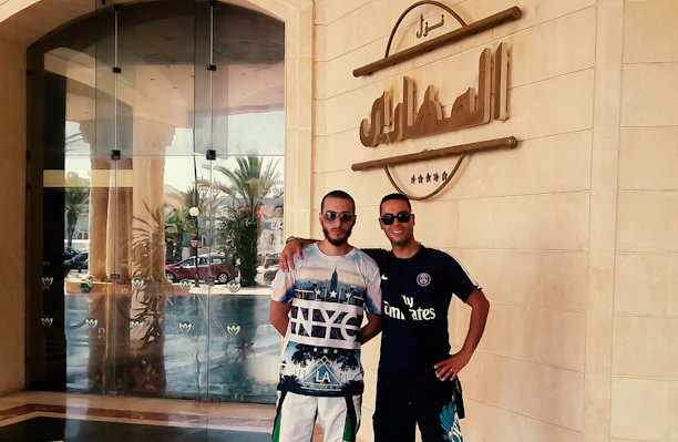 Jan Simon and Daniel Simon warmly greeting a client outside their California therapy office.