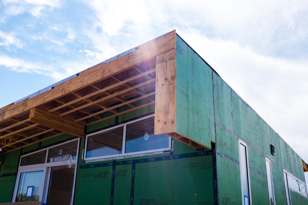 green wooden building during daytime