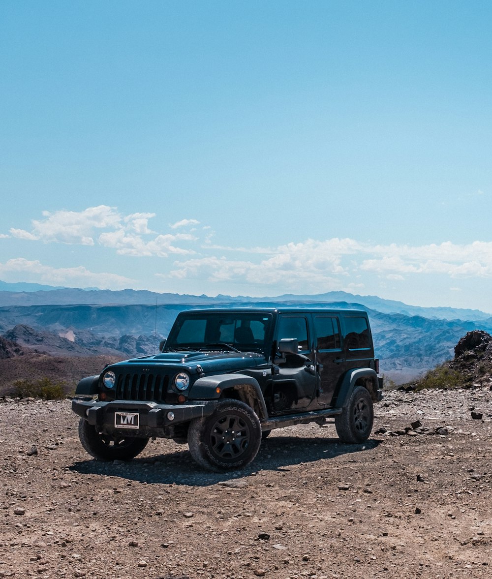 black Jeep SUV under calm blue sky